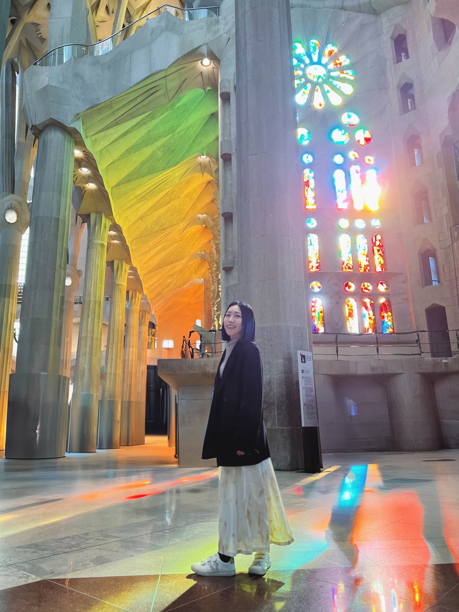 Shanna in coloured light from the stained glass inside the Sagrada Família