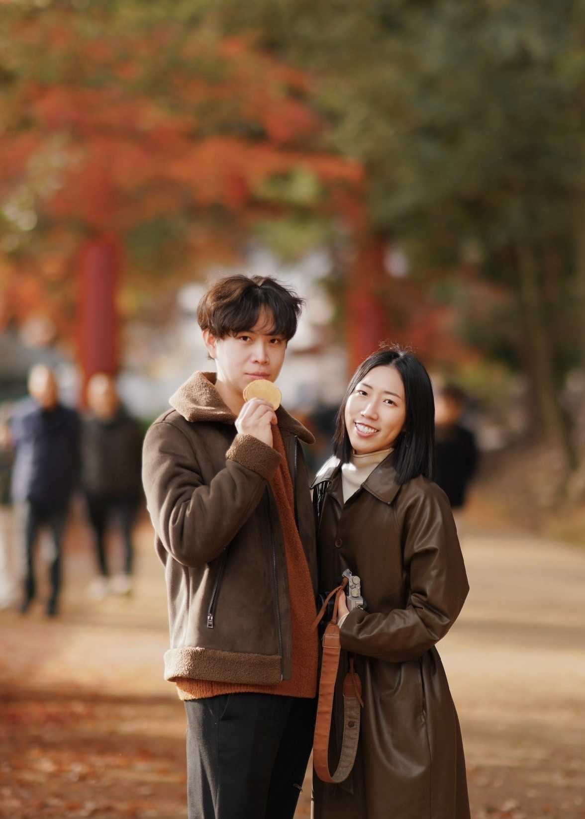 Shanna and Martin under autumn leaves in Japan