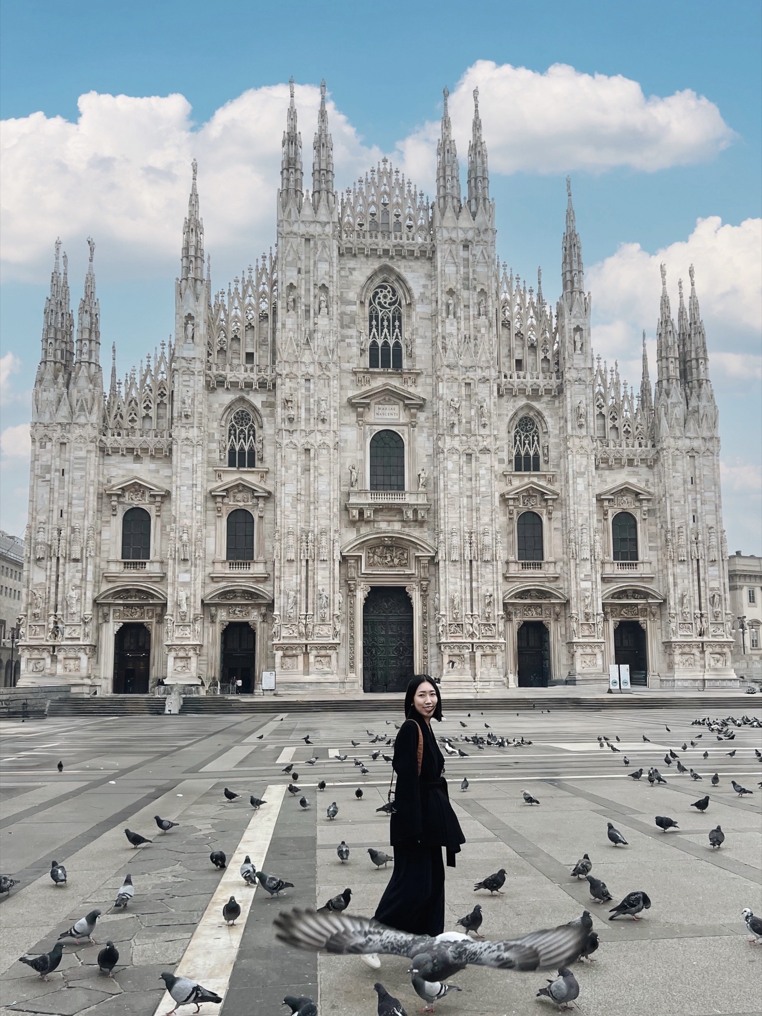 Shanna in front of Milan Cathedral among pigeons