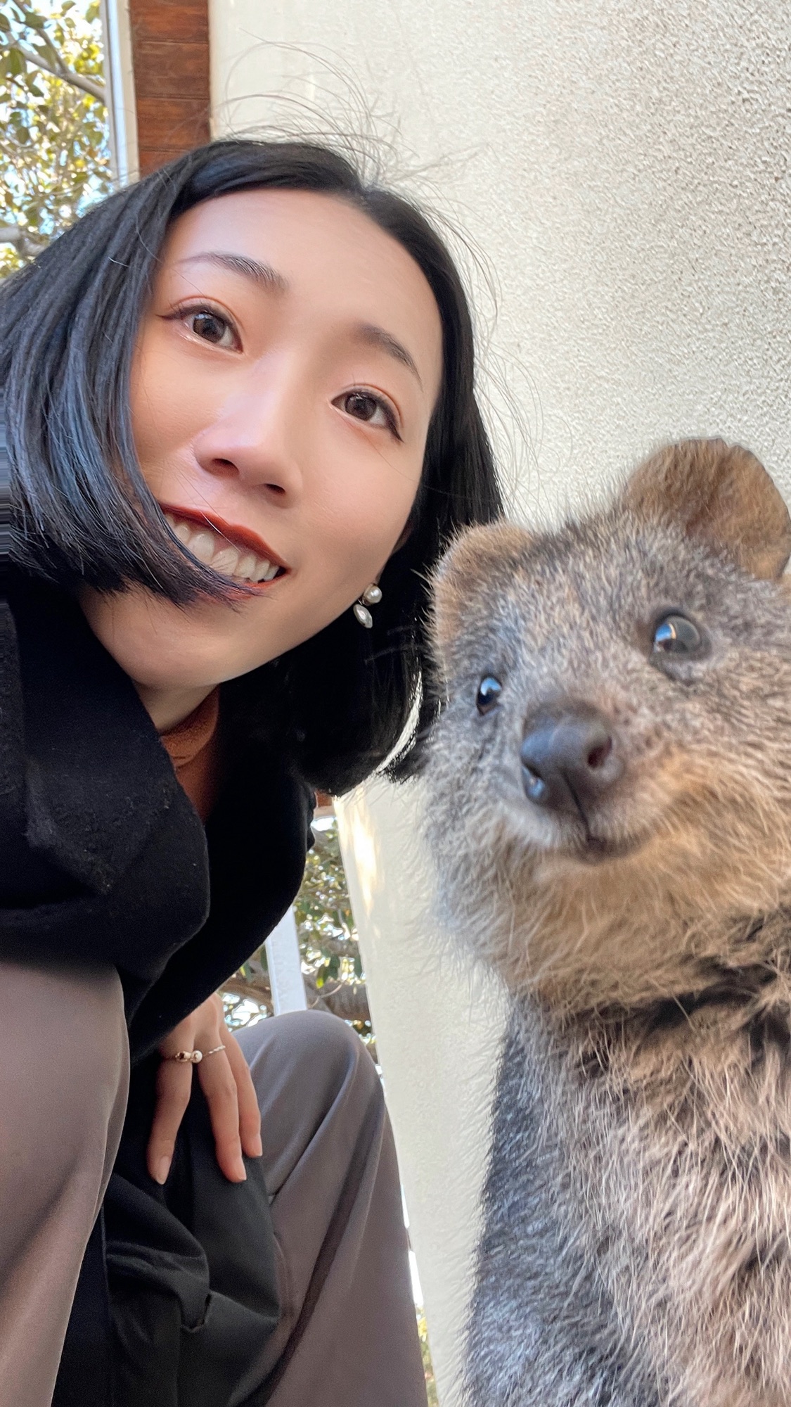 Shanna taking a selfie with a quokka
