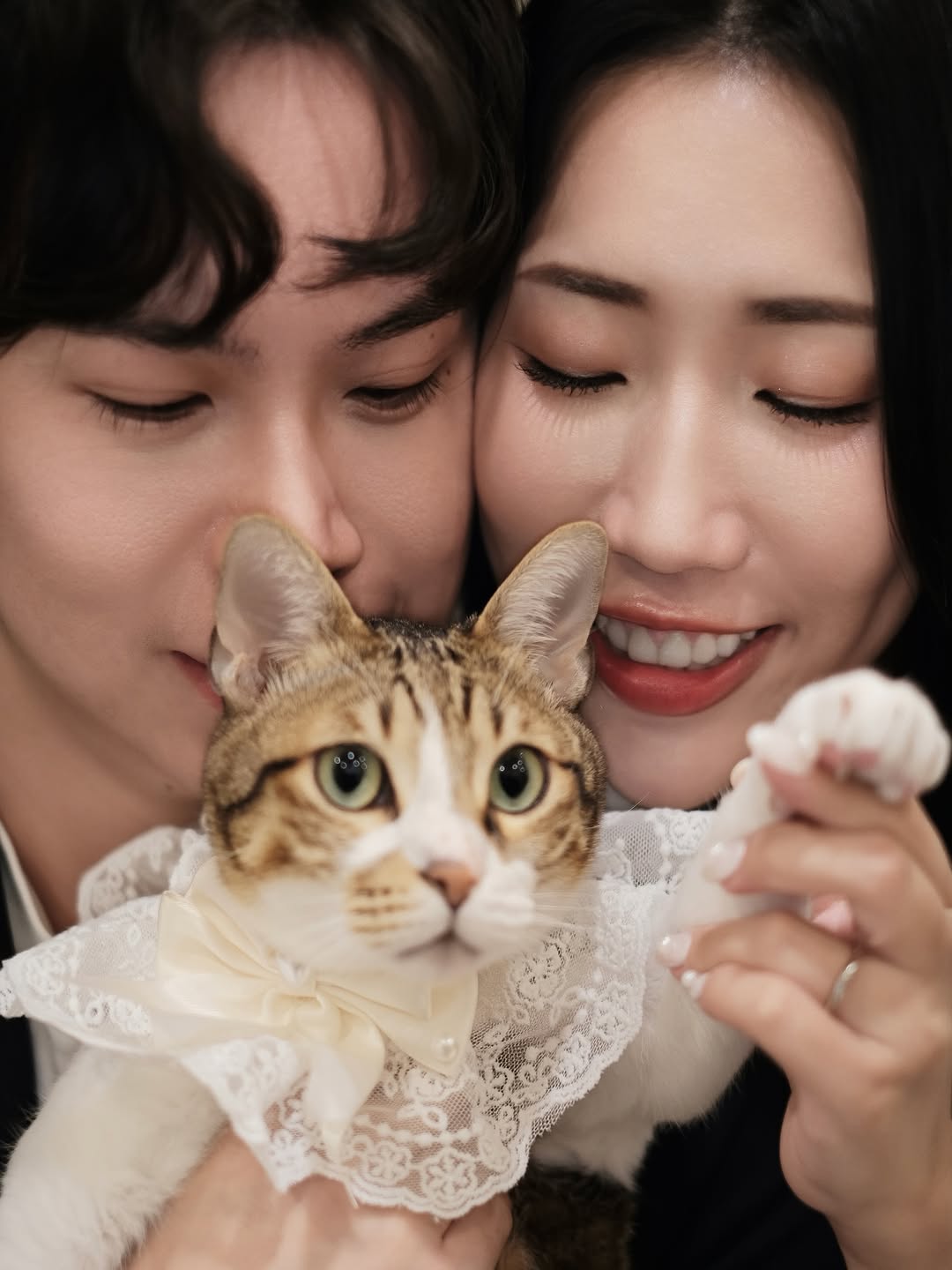 Shanna and Martin holding their cat between them