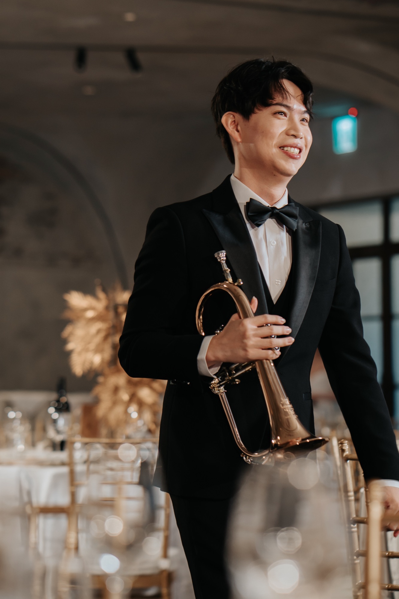 Martin in a tuxedo holding a brass horn